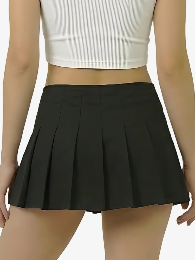 Black pleated skirt worn by a person on a plain background