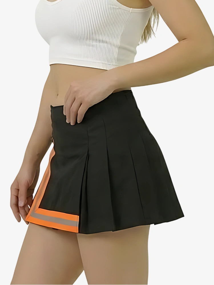 Black pleated skirt with orange accents worn by a person on a white background