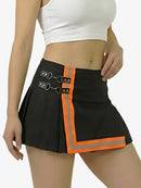 Black skirt with orange accents worn by a person on a white background