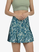 Person wearing a green crop top and blue camouflage skirt on a white background