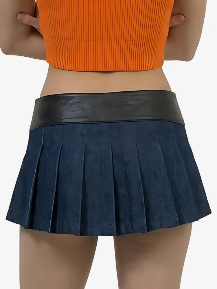 Person wearing a navy pleated skirt with a black waistband on a white background