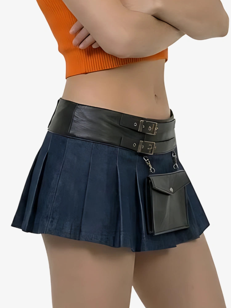 Person wearing a navy pleated skirt with black leather accents on a white background