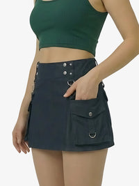 Person wearing a dark green top and black skirt with multiple pockets on a white background