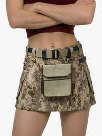 Person wearing a camouflage skirt with a belt and pouch on a white background