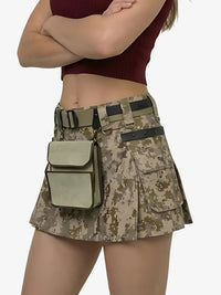 Person wearing a camouflage skirt with a belt and pouch on a white background
