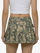 Camouflage skirt worn by a person on a white background