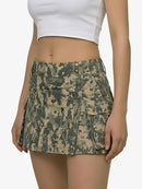 Camouflage skirt worn by a person on a white background