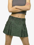 Green pleated skirt worn by a person on a white background