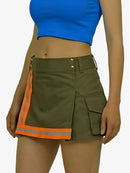 Person wearing a green skirt with orange accents and a blue top on a white background