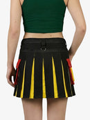 Person wearing a black pleated skirt with yellow and red accents on a white background