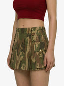 Camouflage skirt worn by a person on a white background