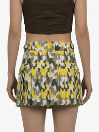 Person wearing a patterned skirt with a plain background