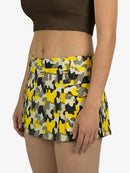 Person wearing a yellow and black patterned skirt on a white background