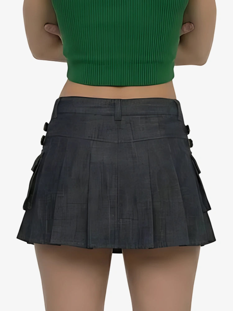 Person wearing a green top and black pleated skirt on a white background