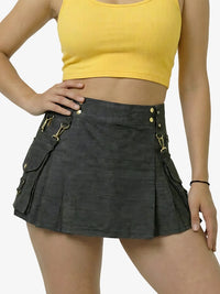 Person wearing a black skirt with gold buttons and a yellow top on a white background