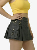 Person wearing a yellow crop top and black skirt with gold buckles on a white background