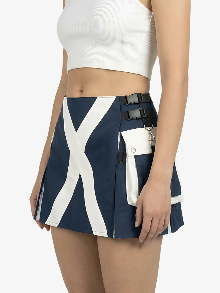Person wearing a navy blue and white skirt with black straps on a white background