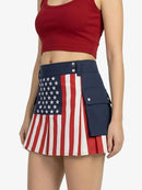 Person wearing a skirt with an American flag design on a plain background