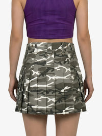 Person wearing a purple top and camouflage skirt on a white background