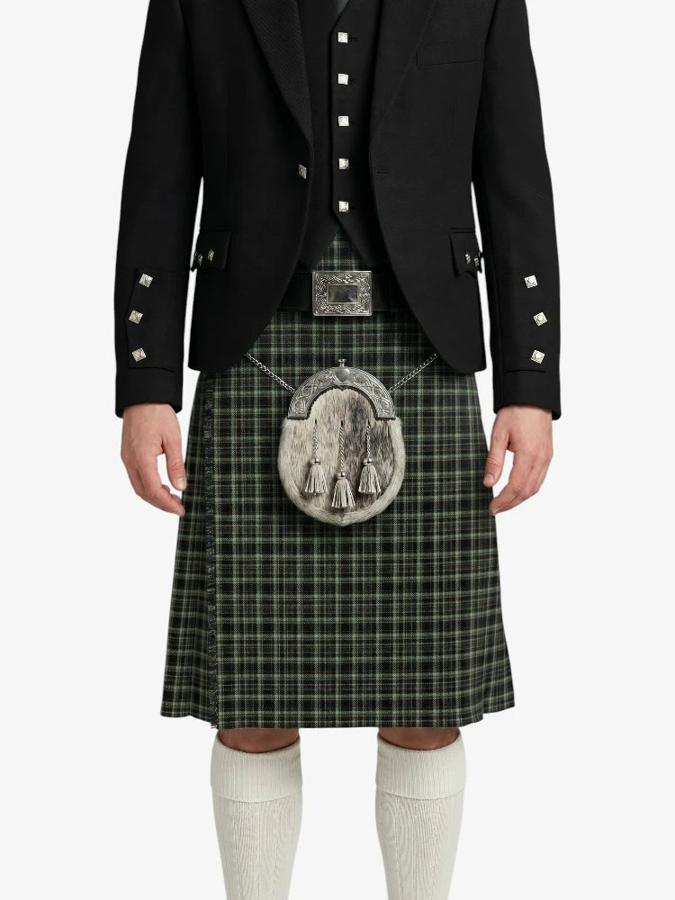 Person wearing a traditional Scottish kilt with a jacket on a white background