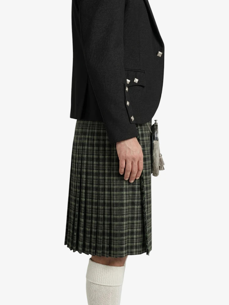 Person wearing a black blazer and plaid kilt on a white background
